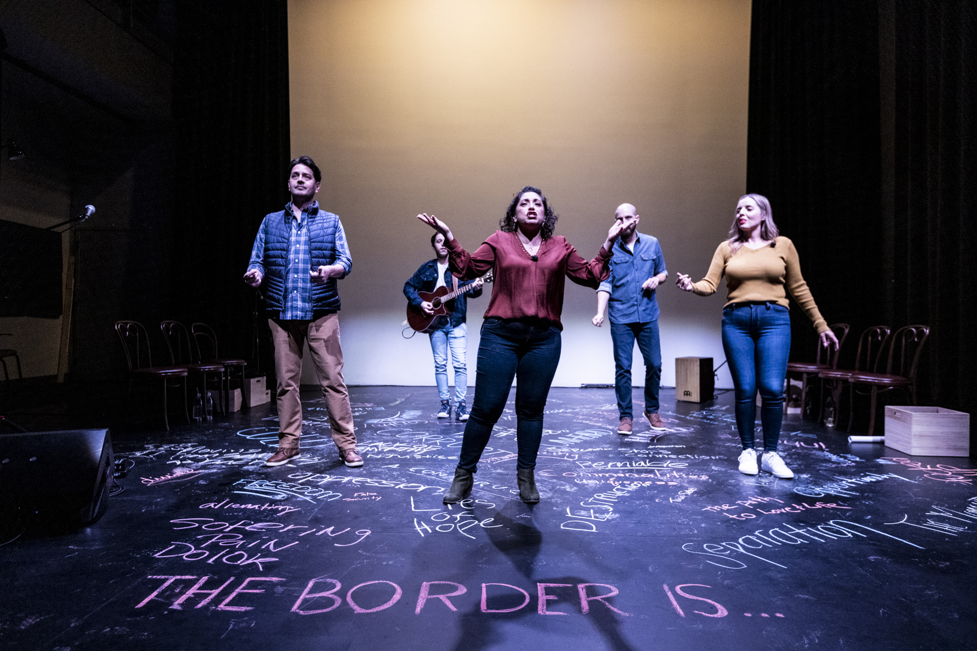 A group of people perform onstage.